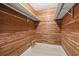 Walk-in closet finished with cedar planking and custom shelving at 482 Rubens Dr E, Nokomis, FL 34275