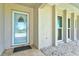 Inviting entryway with a decorative glass door and large windows allowing for ample natural light at 482 Rubens Dr E, Nokomis, FL 34275