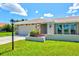 Charming single-story home with a well-kept lawn, stone accents, and an attached garage at 482 Rubens Dr E, Nokomis, FL 34275