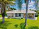 Charming home with stone accents, lush landscaping, and a well-manicured lawn at 482 Rubens Dr E, Nokomis, FL 34275