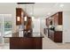 Modern kitchen with a large island, dark wood cabinets, and stainless steel appliances at 482 Rubens Dr E, Nokomis, FL 34275