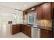 Open kitchen with granite countertops, stainless steel appliances, and views of the backyard pool at 482 Rubens Dr E, Nokomis, FL 34275