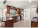 Well-lit kitchen with stainless steel appliances, dark wood cabinets, and granite countertops at 482 Rubens Dr E, Nokomis, FL 34275