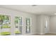 Bright living room features new floors, fresh paint, and a front door with decorative glass at 482 Rubens Dr E, Nokomis, FL 34275