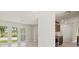 Open-concept living room featuring large windows and seamlessly connects to the kitchen at 482 Rubens Dr E, Nokomis, FL 34275