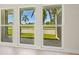 Bright living room with new floors, fresh paint, and large windows with a view of the lush lawn at 482 Rubens Dr E, Nokomis, FL 34275