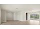 Large, bright living room with new floors, fresh paint, and a sliding glass door that leads to the pool at 482 Rubens Dr E, Nokomis, FL 34275