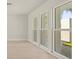 Bright living room with new floors, fresh paint, and large windows with a view of the lush lawn at 482 Rubens Dr E, Nokomis, FL 34275
