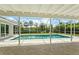 A screened-in pool area offers a tranquil view of the private backyard at 482 Rubens Dr E, Nokomis, FL 34275