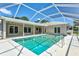 The in-ground pool with screen enclosure is a great place to relax and enjoy the outdoors at 482 Rubens Dr E, Nokomis, FL 34275
