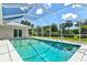 Backyard features an in-ground pool, screened enclosure, and ample space for entertaining at 482 Rubens Dr E, Nokomis, FL 34275
