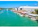 Charming waterfront restaurant with thatched roof, outdoor seating, and docks for boaters at 482 Rubens Dr E, Nokomis, FL 34275