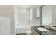 Elegant bathroom featuring white marble tile, a soaking tub, and modern fixtures at 5307 52Nd W Ave, Bradenton, FL 34210
