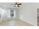 Bright bedroom featuring neutral decor, a ceiling fan, and a large window at 5307 52Nd W Ave, Bradenton, FL 34210