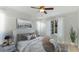 Bright bedroom featuring neutral decor, a ceiling fan, and a large window at 5307 52Nd W Ave, Bradenton, FL 34210