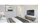 Modern bedroom with neutral tones, sleek furniture, and television at 5307 52Nd W Ave, Bradenton, FL 34210