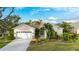 Charming home with mature landscaping, an attached garage, and a well-maintained front yard at 5307 52Nd W Ave, Bradenton, FL 34210