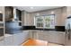 Modern kitchen featuring gray cabinets, granite countertops, stainless steel appliances, and a black backsplash at 5307 52Nd W Ave, Bradenton, FL 34210