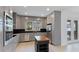 Modern kitchen with stainless steel appliances, sleek cabinetry, stylish island, and views of the outdoors at 5307 52Nd W Ave, Bradenton, FL 34210