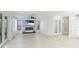 Bright and airy living room with a fireplace, TV, and elegant french doors at 5307 52Nd W Ave, Bradenton, FL 34210