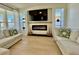Cozy living room with a fireplace and TV, bathed in natural light from large windows at 5307 52Nd W Ave, Bradenton, FL 34210
