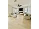 Bright living room featuring plank floors, sofas, ceiling fan, and fireplace at 5307 52Nd W Ave, Bradenton, FL 34210