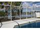 Screened pool area with a clear view of the lake and surrounding palm trees at 5307 52Nd W Ave, Bradenton, FL 34210