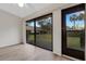 Bright bedroom boasts light wood floors and large sliding glass doors with a backyard view at 5535 Hampstead Heath # 45, Sarasota, FL 34235