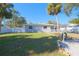 House with a spacious backyard, palm trees, and a white fence at 5611 26Th W St, Bradenton, FL 34207
