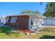 Side view of mid-century modern home with brick exterior and landscaping at 5611 26Th W St, Bradenton, FL 34207