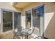 Small balcony with glass-top table and chairs, adjacent to sliding doors at 6101 34Th W St # 19H, Bradenton, FL 34210