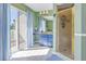 Bathroom with walk-in shower, vanity, and access to private balcony at 6101 34Th W St # 19H, Bradenton, FL 34210