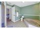 Bathroom with bathtub, toilet and access to bedroom at 6101 34Th W St # 19H, Bradenton, FL 34210
