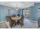 Dining area with wood table and wicker chairs, and access to a balcony at 6101 34Th W St # 19H, Bradenton, FL 34210