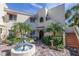 Building exterior with lush landscaping and fountain at 6101 34Th W St # 19H, Bradenton, FL 34210