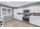 Modern kitchen with white cabinets and light wood floors at 6101 34Th W St # 19H, Bradenton, FL 34210