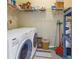 Functional laundry room with washer, dryer, and ample shelving at 6101 34Th W St # 19H, Bradenton, FL 34210