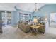 Spacious living room with vaulted ceiling and access to a screened patio at 6101 34Th W St # 19H, Bradenton, FL 34210