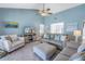 Living room with comfy sofas, a striped ottoman, and a large TV at 6101 34Th W St # 19H, Bradenton, FL 34210