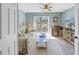 Spacious living area featuring a sofa, desk, and balcony access at 6101 34Th W St # 19H, Bradenton, FL 34210