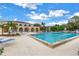Large community pool with surrounding lounge chairs and building in background at 6101 34Th W St # 19H, Bradenton, FL 34210