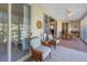 Bright sunroom with wicker furniture and access to the outdoors at 6101 34Th W St # 19H, Bradenton, FL 34210
