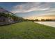 Expansive green backyard featuring manicured lawn and stunning lake views at 8328 Sea Glass Ct, Sarasota, FL 34240