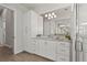 Modern bathroom featuring a large mirror and a marble shower, paired with white cabinetry for a serene space at 8328 Sea Glass Ct, Sarasota, FL 34240