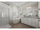 Beautiful bathroom showcasing a soaking tub, glass shower, stylish vanity with a modern design, and wood-look flooring at 8328 Sea Glass Ct, Sarasota, FL 34240