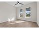 Sun-filled bedroom has wood look tile, two bright windows and neutral walls for ultimate relaxation at 8328 Sea Glass Ct, Sarasota, FL 34240