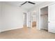 Spacious bedroom featuring a ceiling fan, wood look tile, access to a closet, and access to the ensuite bathroom at 8328 Sea Glass Ct, Sarasota, FL 34240