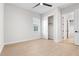 This bedroom is a blank canvas with wood look tile, a ceiling fan, a window, and a closet at 8328 Sea Glass Ct, Sarasota, FL 34240