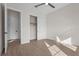 Bright bedroom featuring wood floors, a ceiling fan and closet with a white sliding door at 8328 Sea Glass Ct, Sarasota, FL 34240