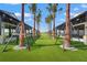 Lush green lawn adorned with palm trees strung with lights creating a welcoming social space at 8328 Sea Glass Ct, Sarasota, FL 34240